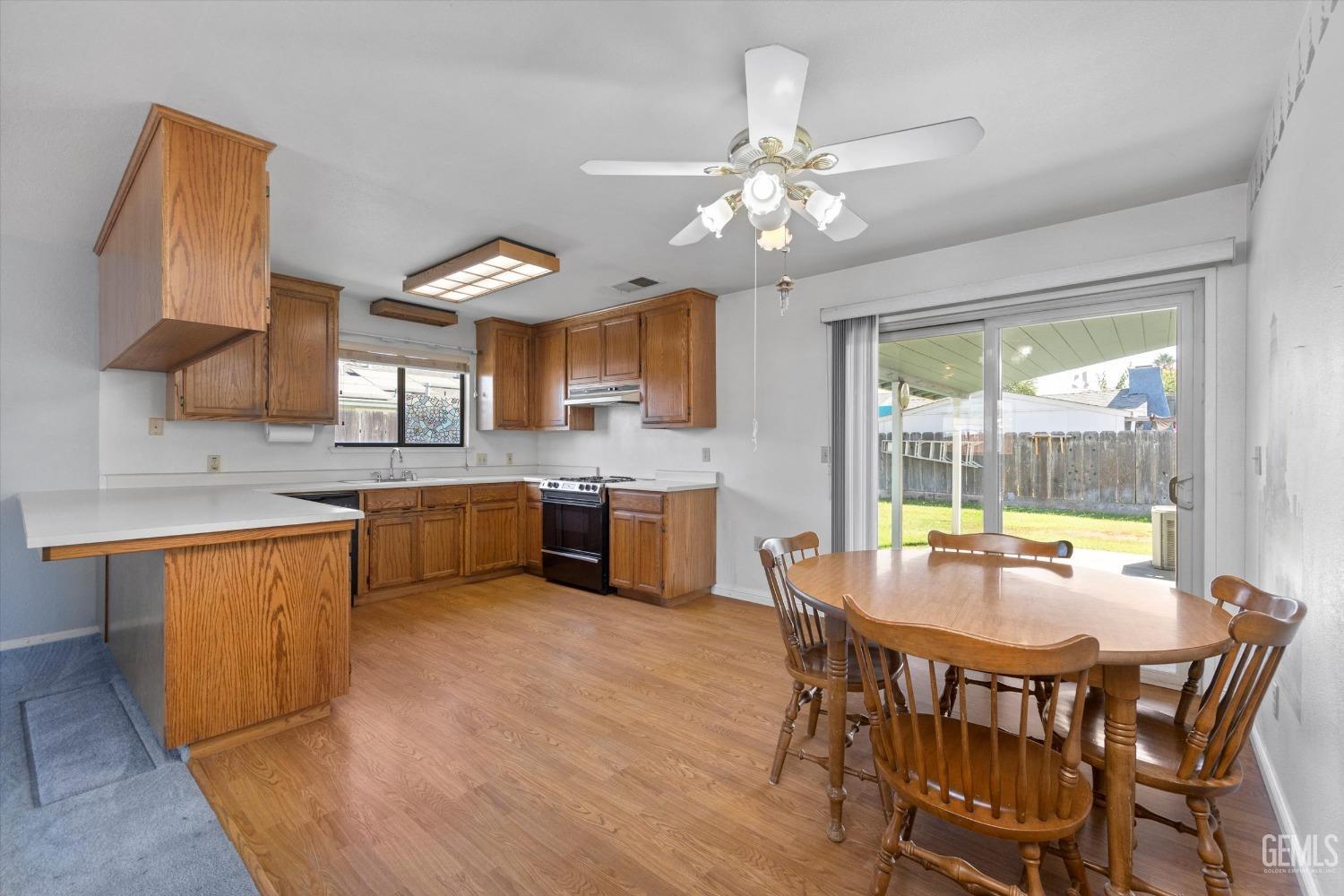 Undisclosed Address Chowchilla, CA 93610 - Photo 14 of 29 a view of a dining room with furniture a chandelier and kitchen view