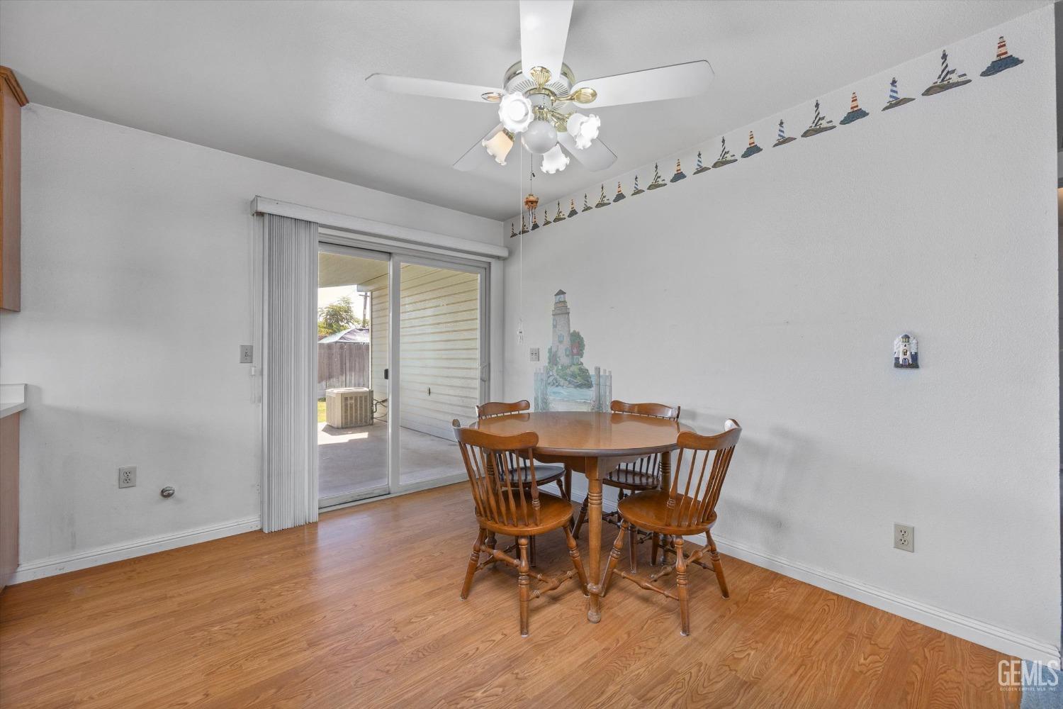 Undisclosed Address Chowchilla, CA 93610 - Photo 15 of 29 a view of a dining room with furniture window and wooden floor
