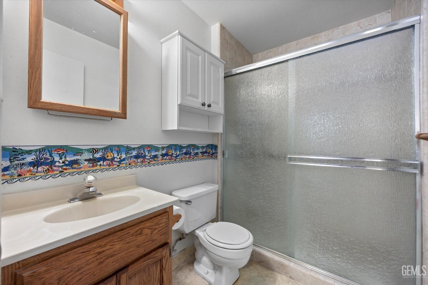 Undisclosed Address Chowchilla, CA 93610 - Photo 19 of 29 a bathroom with a sink and a mirror
