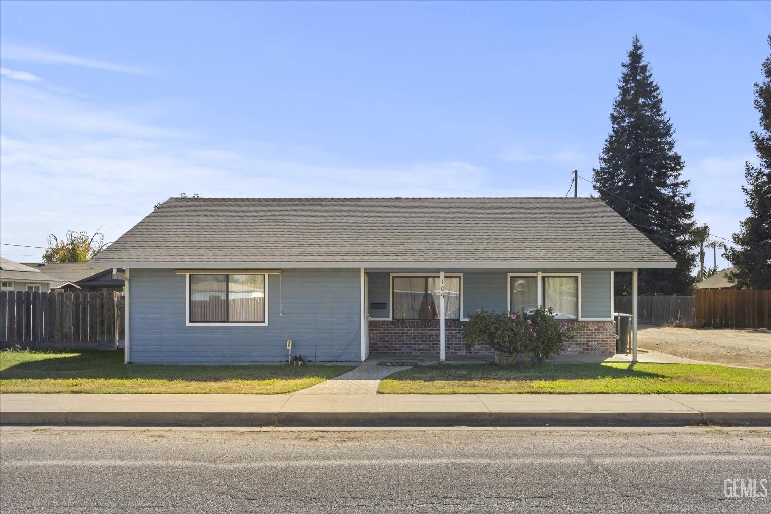 Undisclosed Address Chowchilla, CA 93610 - Photo 2 of 29 a view of a house with a patio and a yard