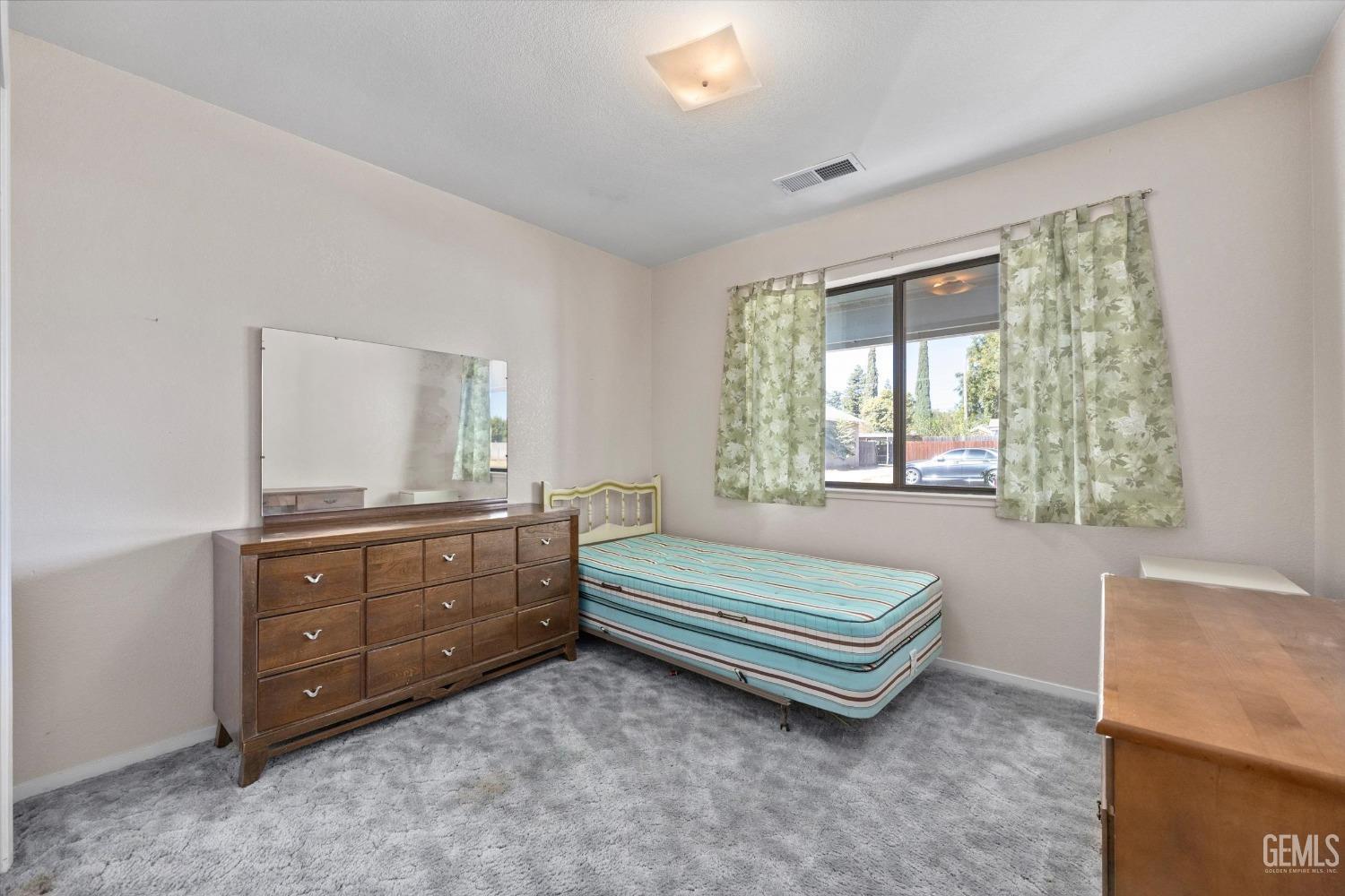 Undisclosed Address Chowchilla, CA 93610 - Photo 23 of 29 a room with a dresser and a window