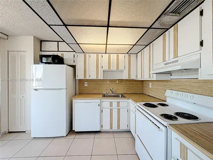 a view of balcony with double vanity and glass door