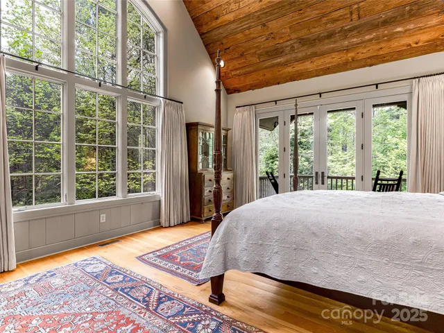a bed sitting in a bedroom next to a window