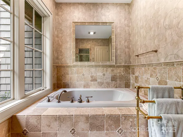 a bathroom with a bathtub and shower