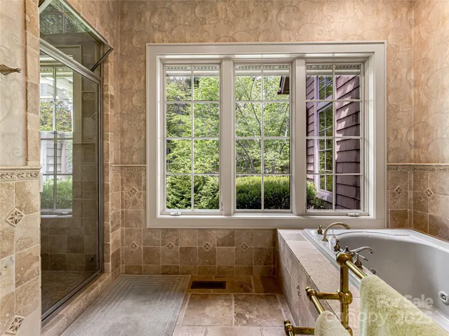 a bath tub sitting in a bathroom next to a window