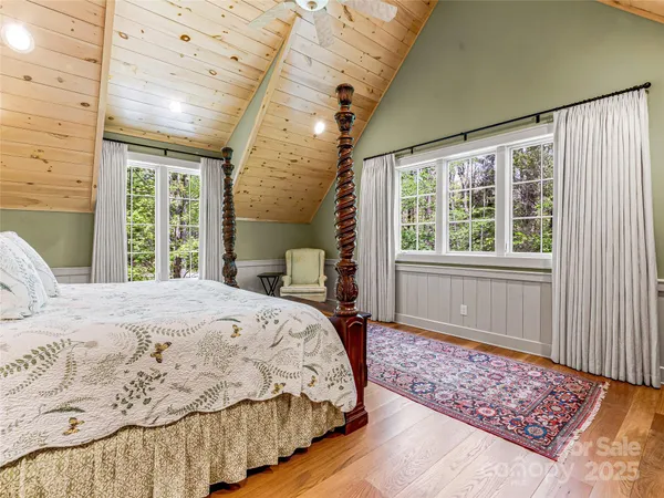a bedroom with a large bed and a window