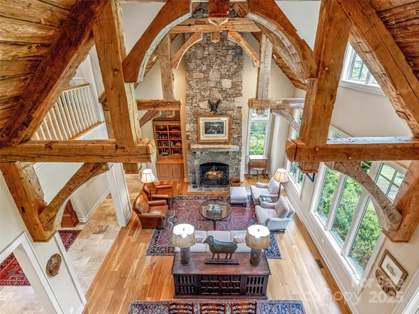 a living room with fireplace furniture and a floor to ceiling window