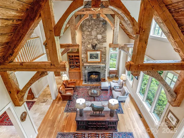 a living room with fireplace furniture and a floor to ceiling window