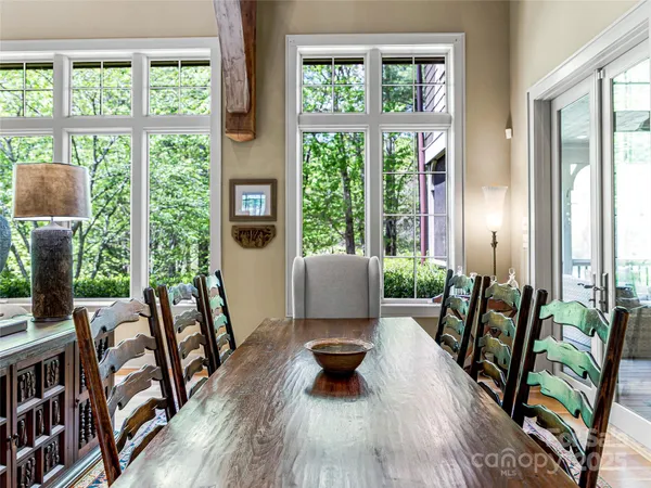 a living room with furniture and floor to ceiling windows