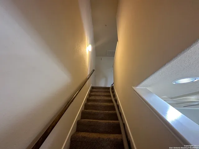 a view of a livingroom with a ceiling fan and window