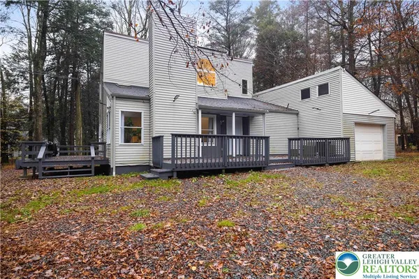 a view of a house with wooden floor and a yard