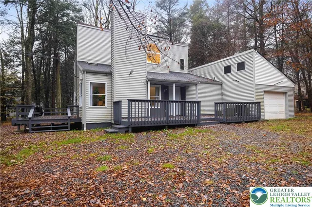 a view of a house with wooden floor and a yard