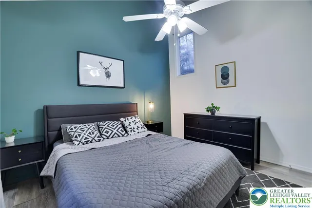 a bedroom with a bed and a chandelier