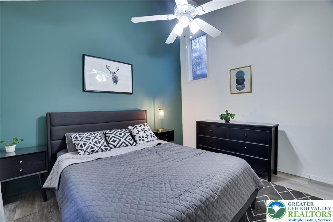 421 King Arthur Road Pocono Lake, PA 18347 - Photo 16 of 29 a bedroom with a bed and a chandelier