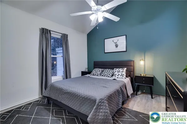 a bedroom with a bed and a lamp on table