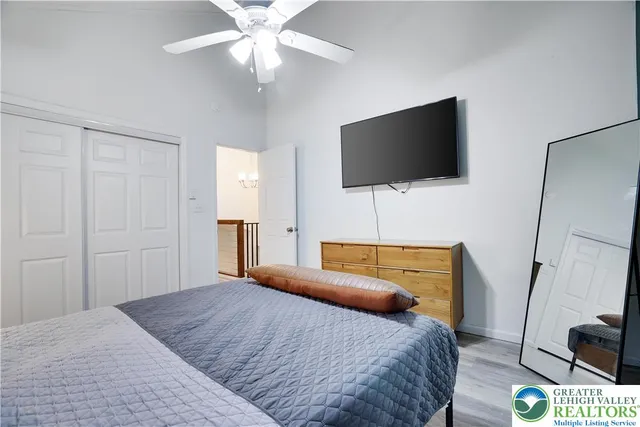 a bedroom with a bed and a flat screen tv
