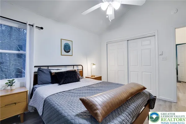 a bedroom with a bed and a chandelier