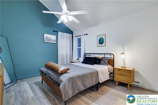 a bedroom with a bed and a chandelier