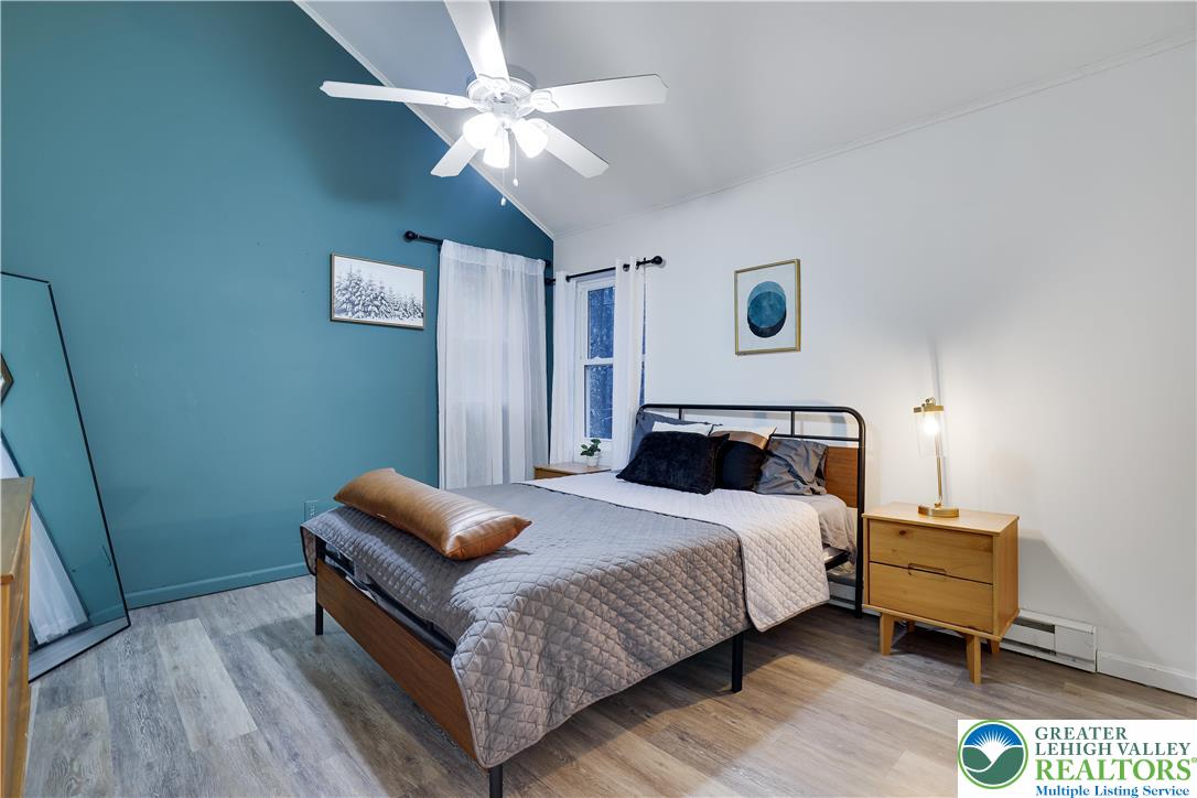 421 King Arthur Road Pocono Lake, PA 18347 - Photo 20 of 29 a bedroom with a bed and a chandelier