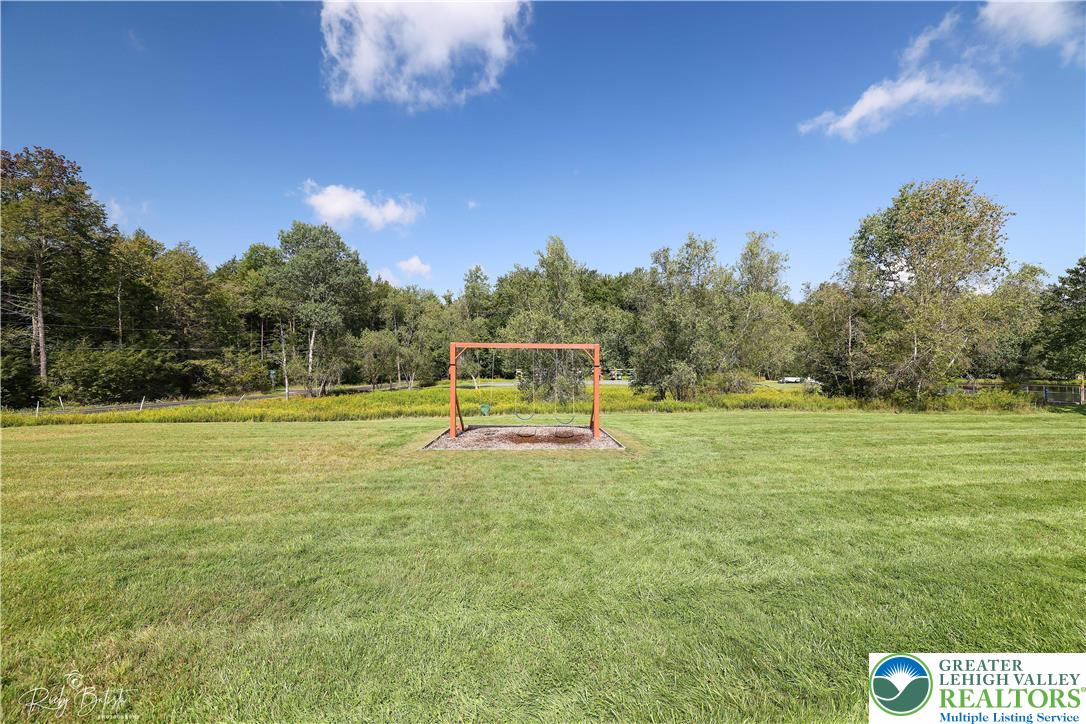421 King Arthur Road Pocono Lake, PA 18347 - Photo 28 of 29 a view of a swimming pool with an outdoor space and seating area