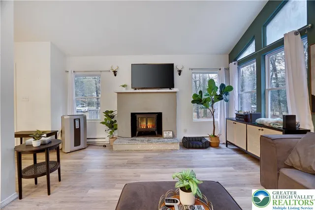 a living room with furniture and a fireplace