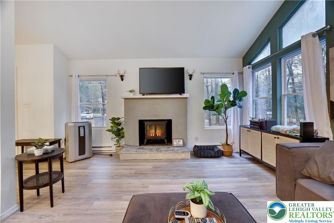 421 King Arthur Road Pocono Lake, PA 18347 - Photo 5 of 29 a living room with furniture and a fireplace