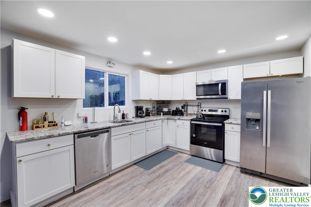 421 King Arthur Road Pocono Lake, PA 18347 - Photo 8 of 29 a kitchen with stainless steel appliances granite countertop a refrigerator and a stove top oven