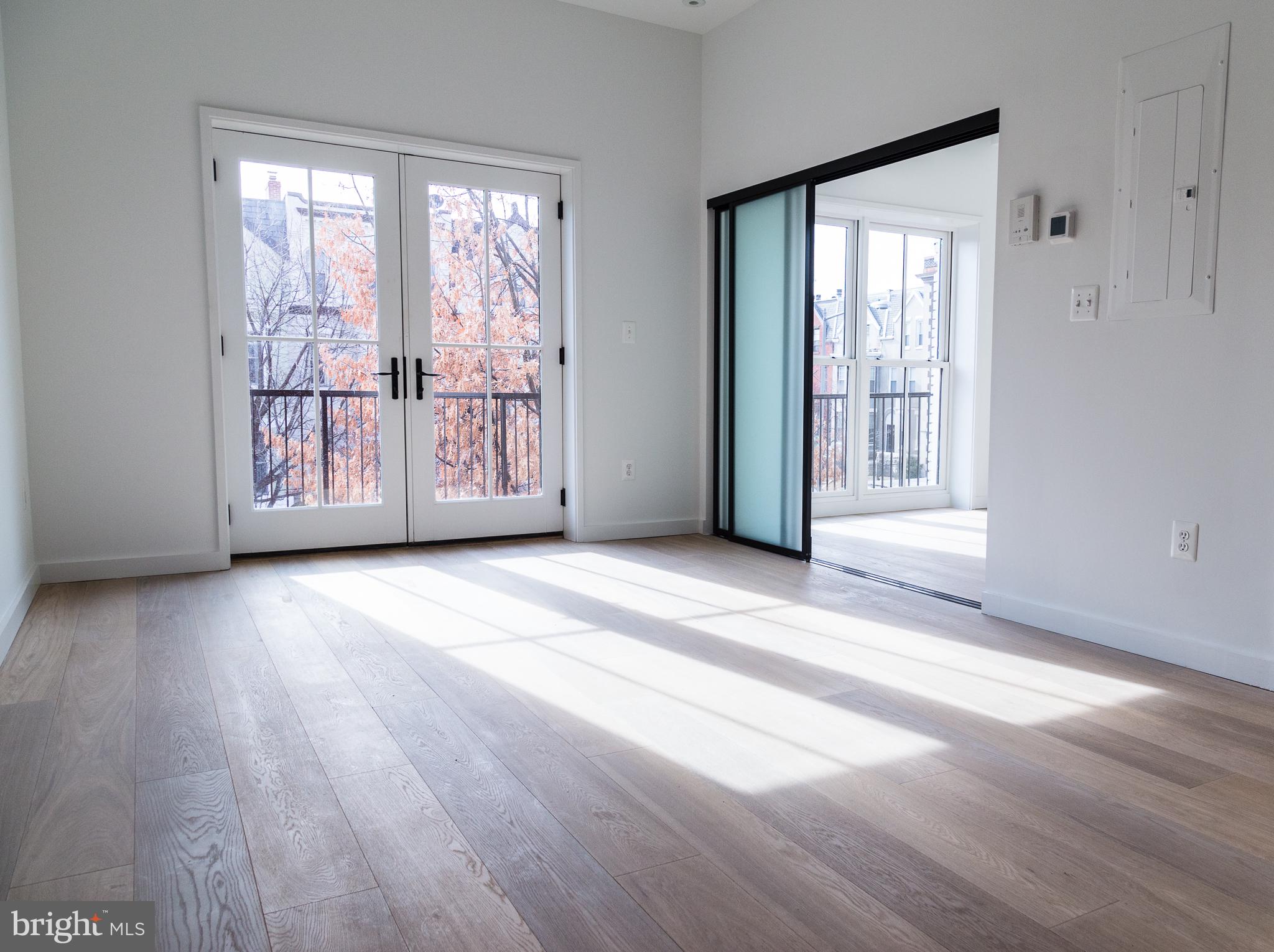 a view of a room with wooden floor and windows