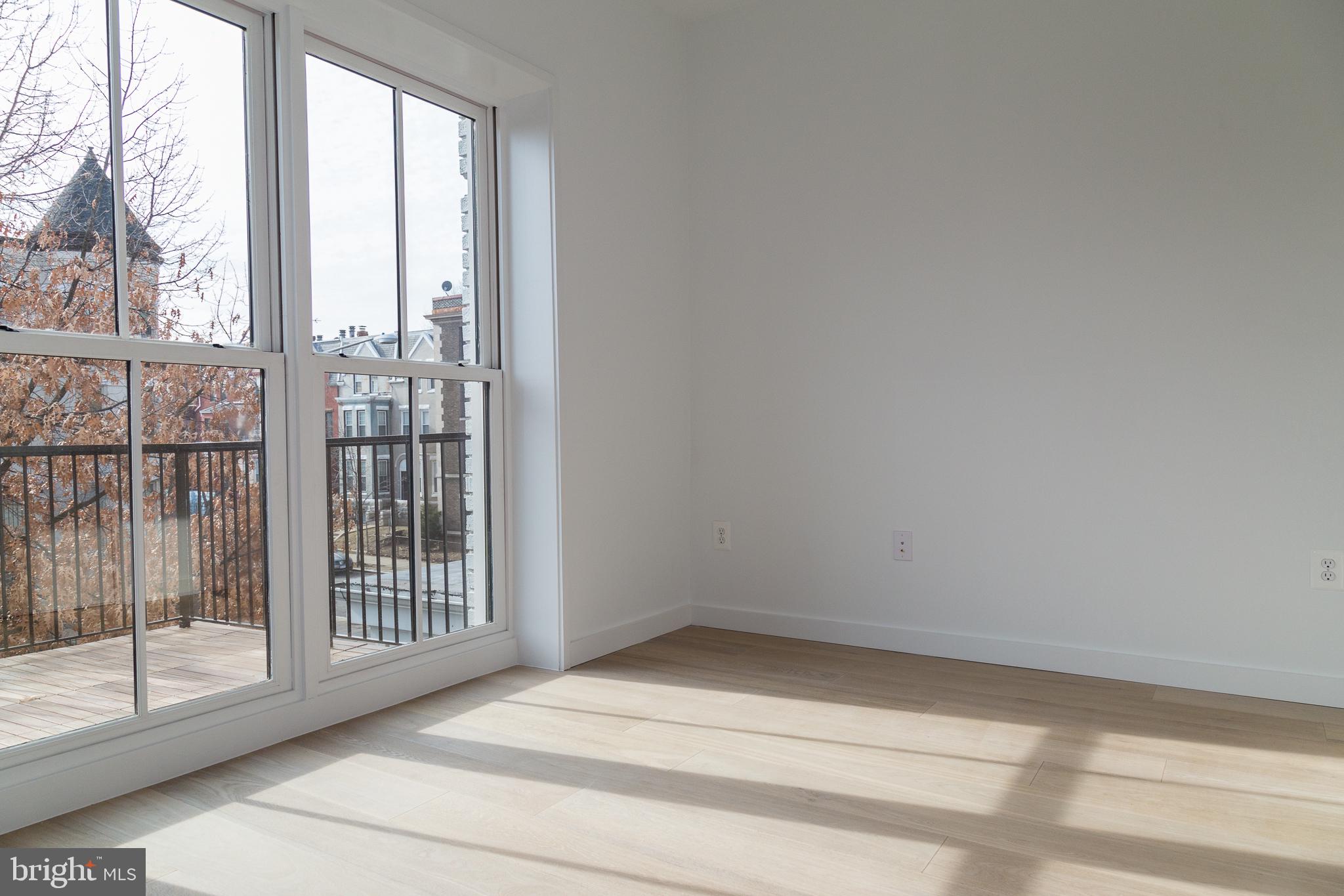1443 Euclid Street Northwest, Unit 5 Washington, DC 20009 - Photo 3 of 13 a view of empty room with floor to ceiling window