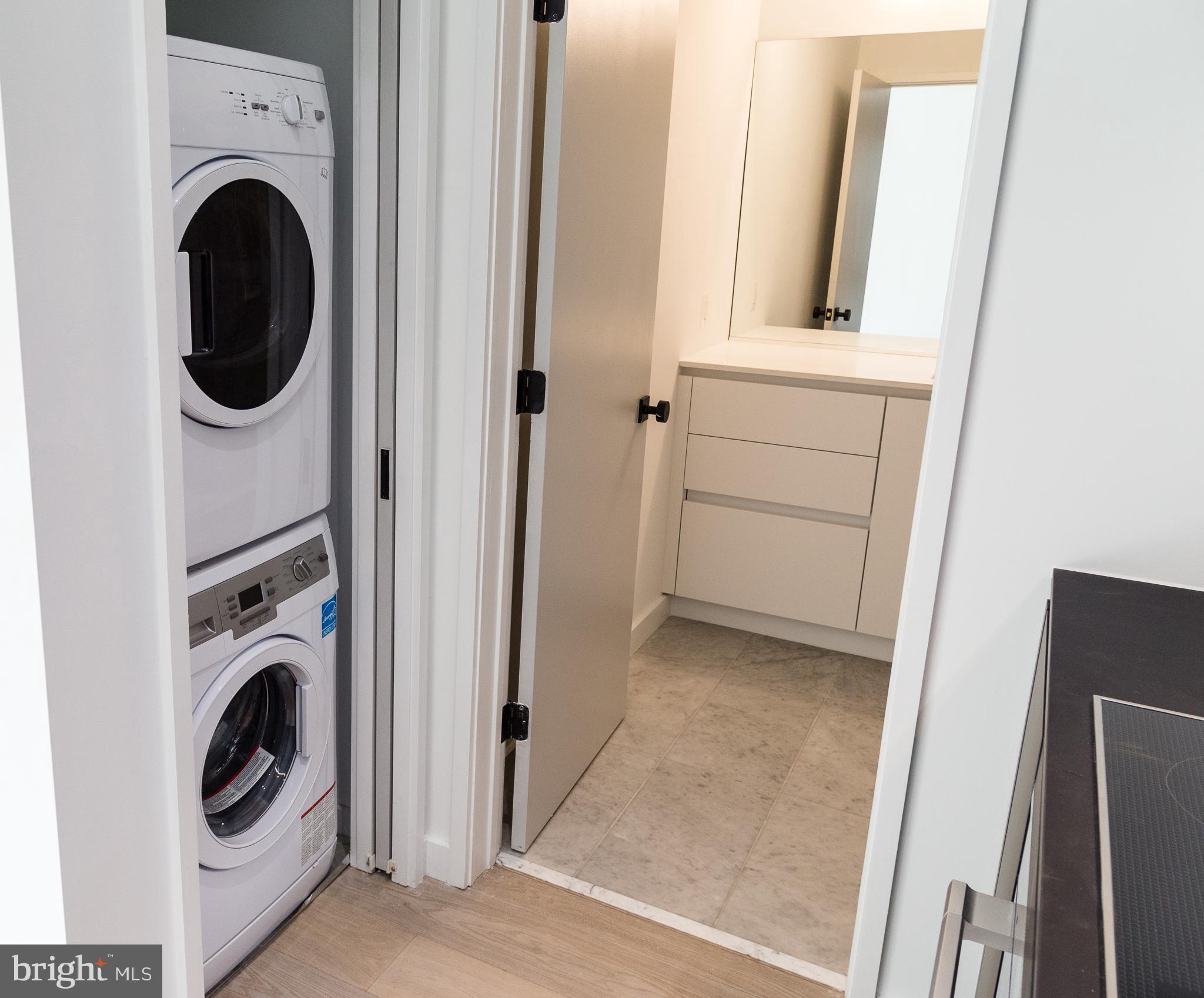 1443 Euclid Street Northwest, Unit 5 Washington, DC 20009 - Photo 8 of 13 a view of a hallway with washer and dryer