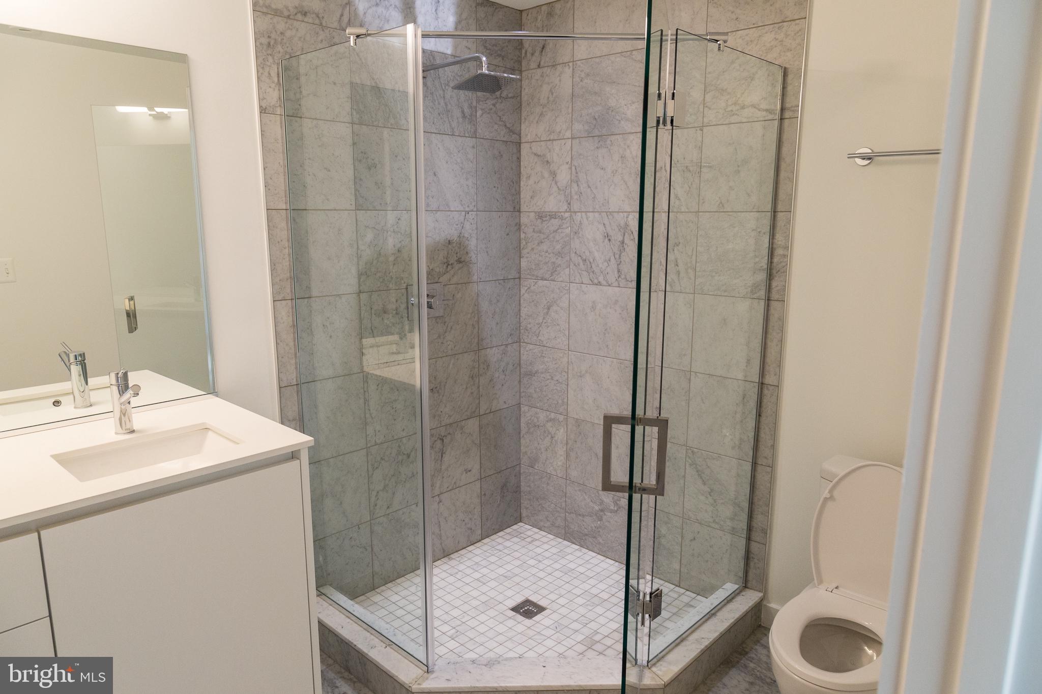 1443 Euclid Street Northwest, Unit 5 Washington, DC 20009 - Photo 9 of 13 a bathroom with a sink mirror and shower