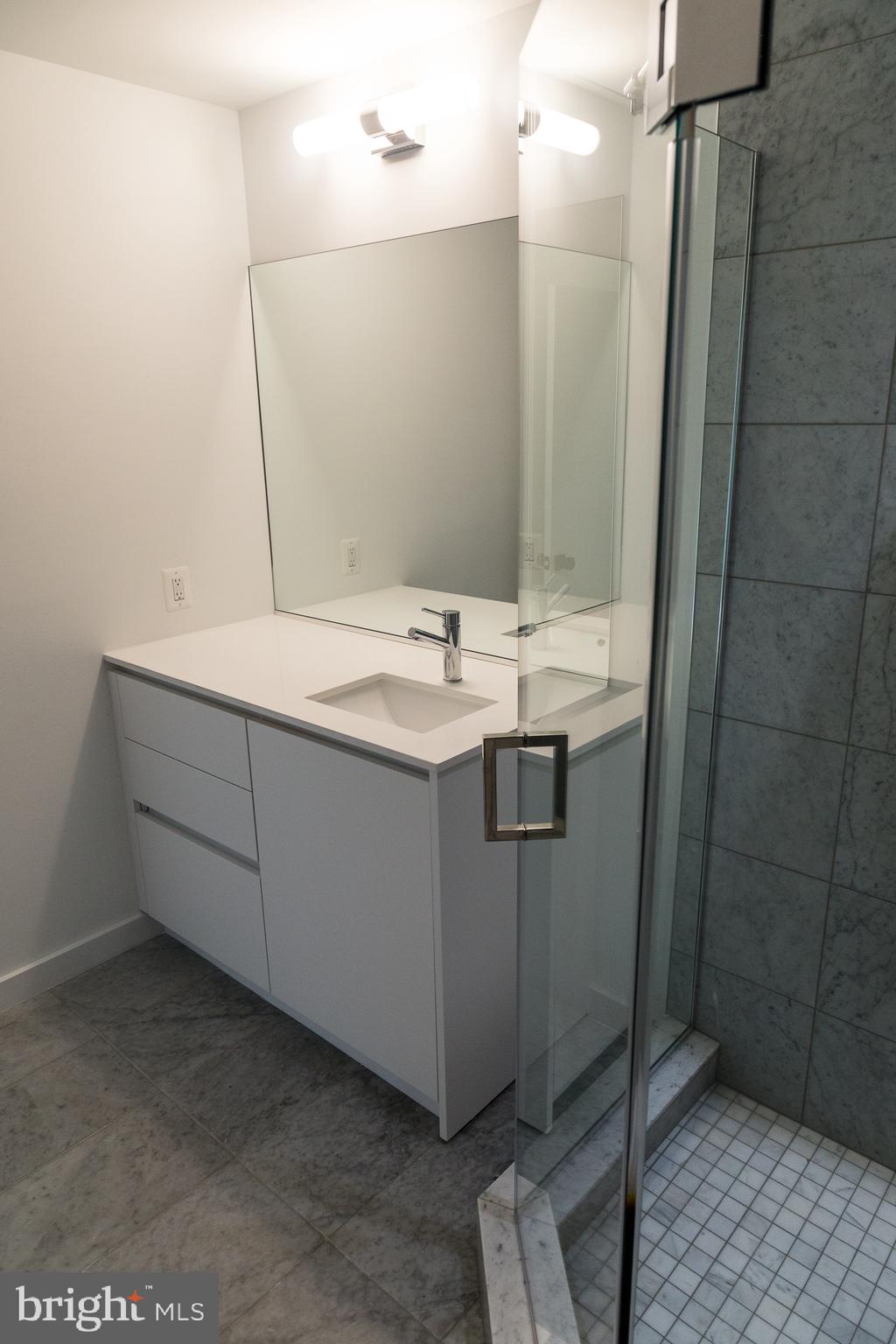 1443 Euclid Street Northwest, Unit 5 Washington, DC 20009 - Photo 10 of 13 a bathroom with a sink a toilet and a mirror