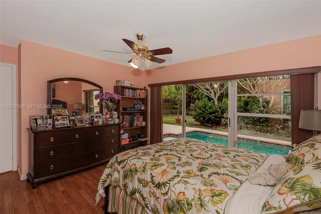 a bedroom with a bed a dresser and book shelf