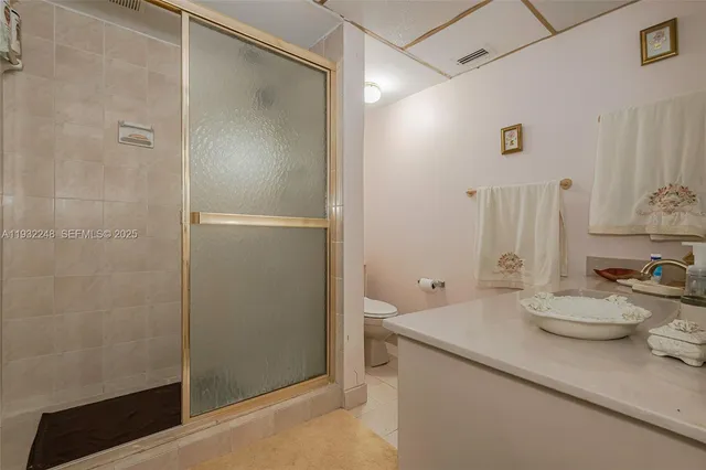 a bathroom with a sink a toilet and mirror