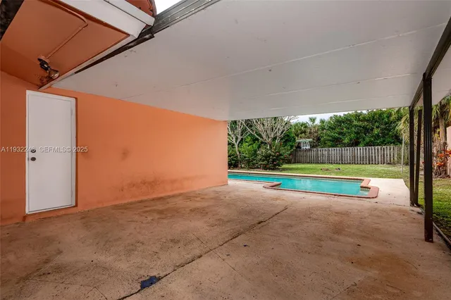 a view of swimming pool with a patio and a yard