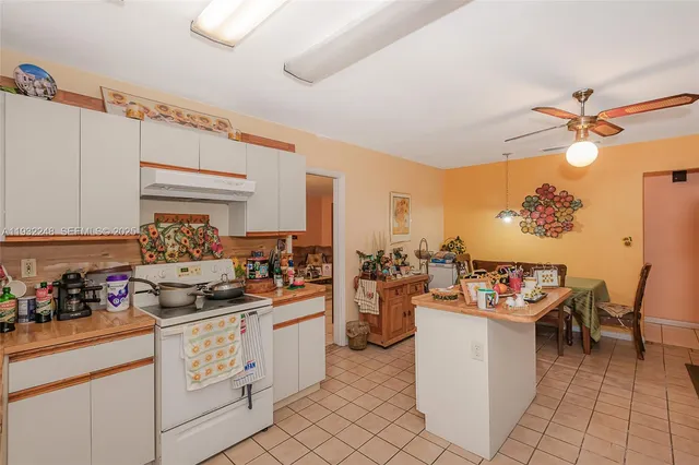 a view of a dining room with furniture and a potted plant