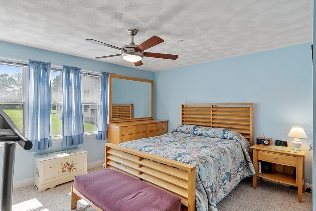 216 Rangeway Road, Unit 183 Billerica, MA 01862 - Photo 19 of 35 a bedroom with a bed and a chandelier