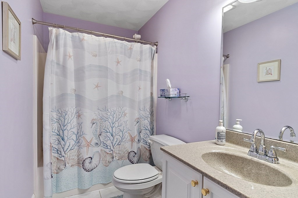 216 Rangeway Road, Unit 183 Billerica, MA 01862 - Photo 20 of 35 a bathroom with a granite countertop toilet a sink and a mirror