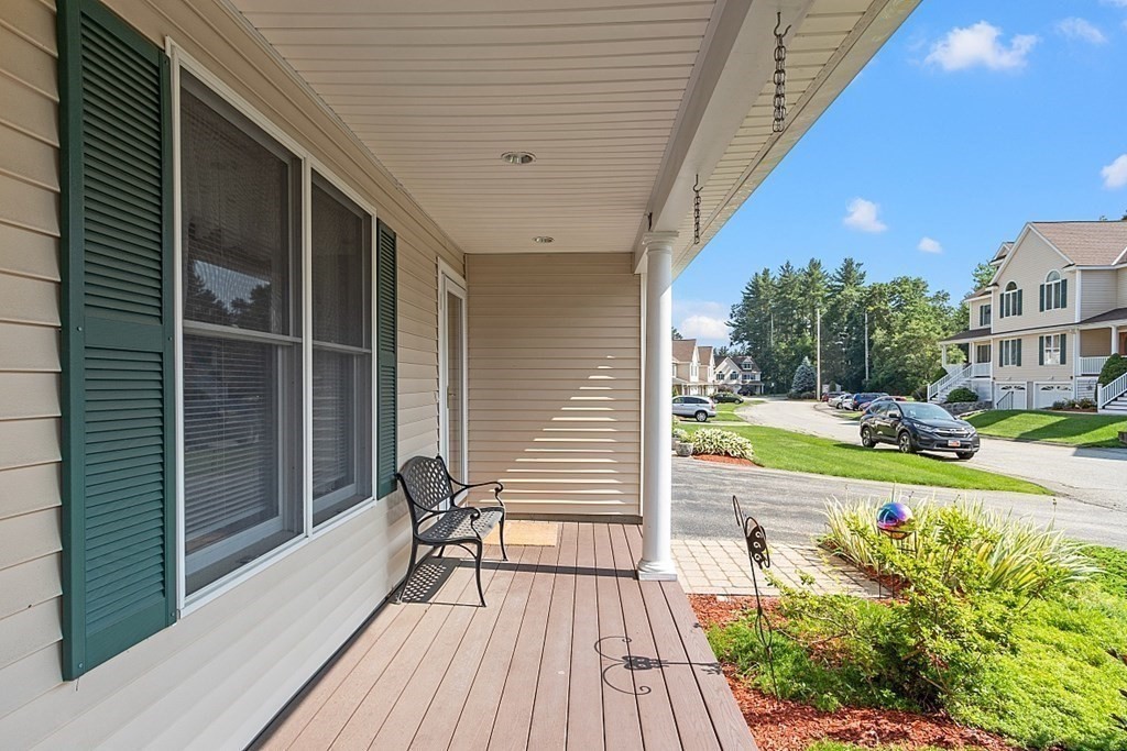 216 Rangeway Road, Unit 183 Billerica, MA 01862 - Photo 29 of 35 a view of a balcony with chair and wooden floor