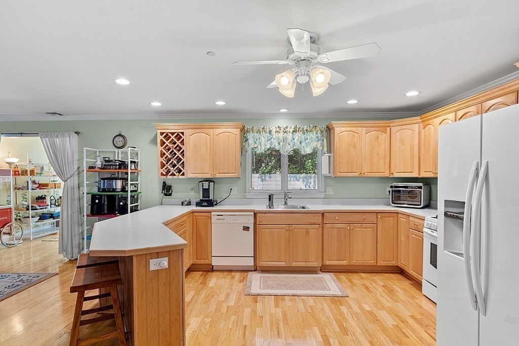 216 Rangeway Road, Unit 183 Billerica, MA 01862 - Photo 8 of 35 a large kitchen with stainless steel appliances a large counter top a stove a chimney a sink and cabinets