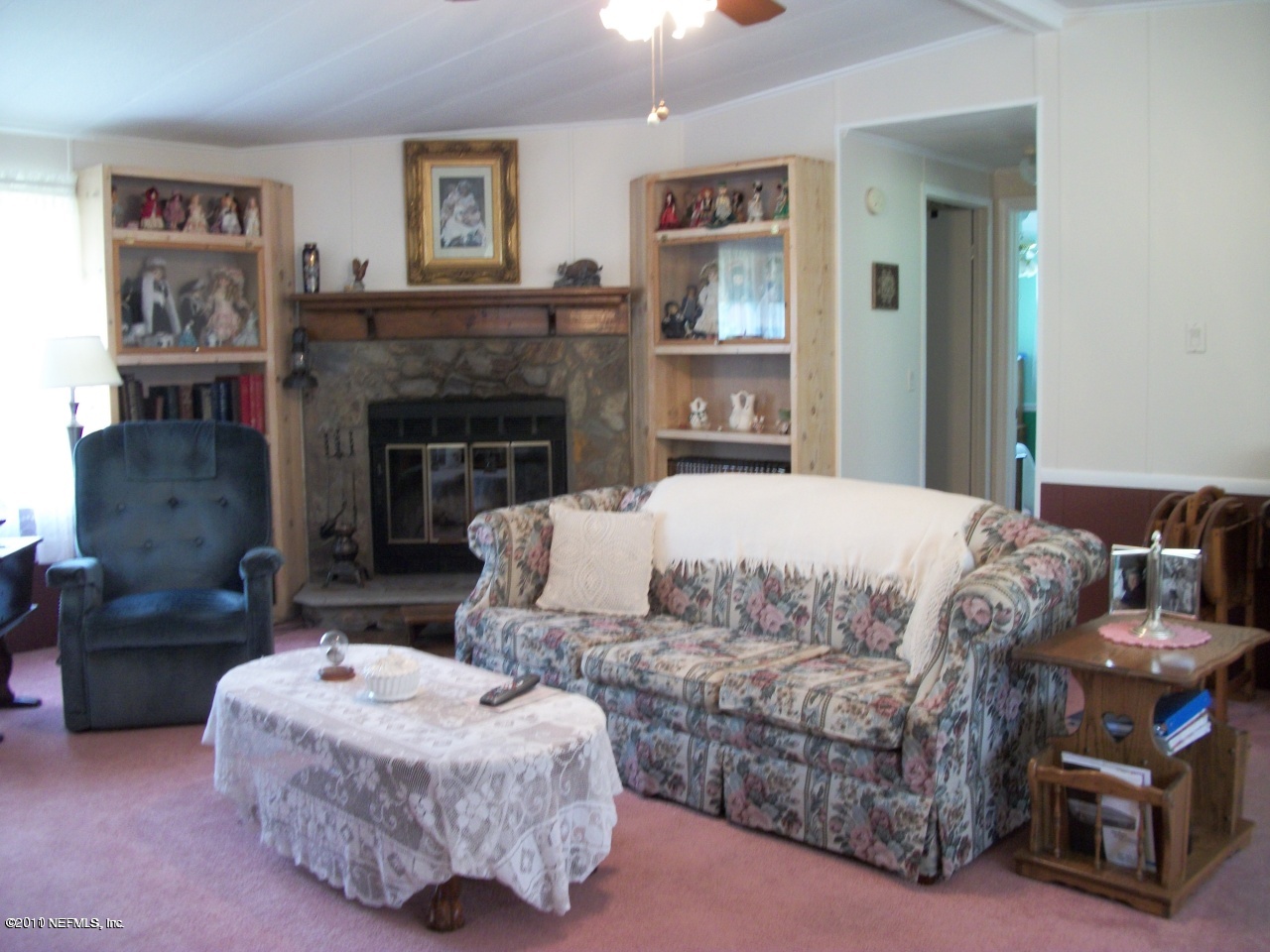 2855 Parrish Cemetery Road Jacksonville, FL 32221 - Photo 12 of 16 a bedroom with a bed a fireplace and a painting on the wall