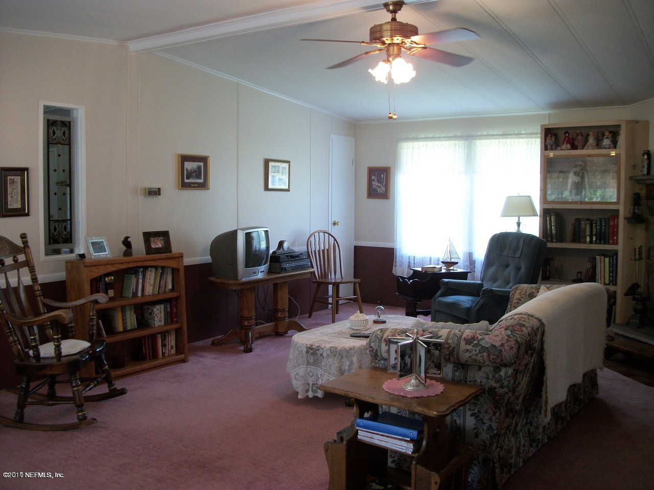 2855 Parrish Cemetery Road Jacksonville, FL 32221 - Photo 13 of 16 a living room with furniture a lamp and a window
