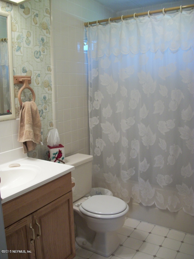 2855 Parrish Cemetery Road Jacksonville, FL 32221 - Photo 16 of 16 a bathroom with a sink a toilet and shower