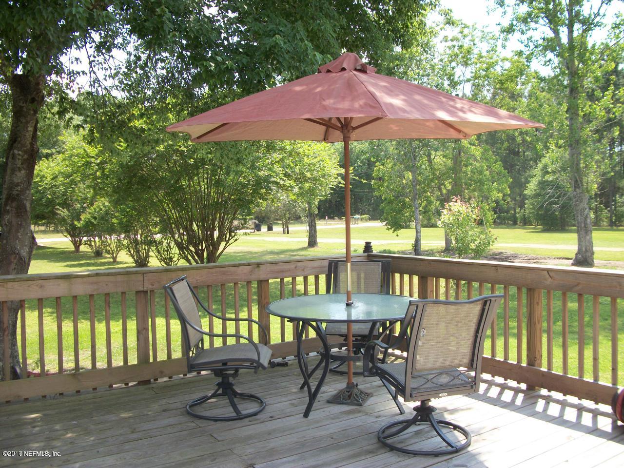 2855 Parrish Cemetery Road Jacksonville, FL 32221 - Photo 3 of 16 a view of balcony with wooden floor and outdoor seating