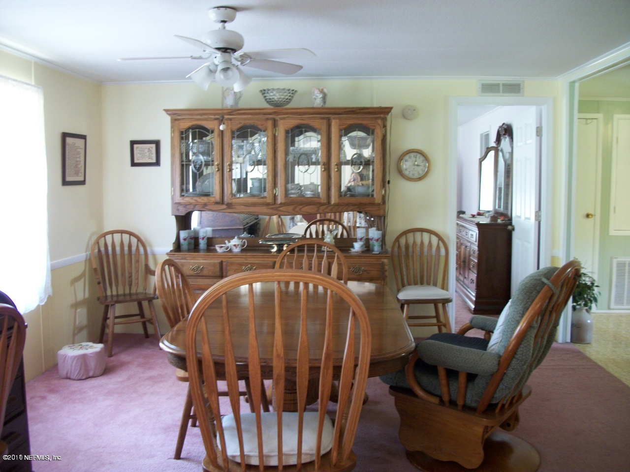 2855 Parrish Cemetery Road Jacksonville, FL 32221 - Photo 7 of 16 a view of a dining room with furniture a chandelier and wooden floor