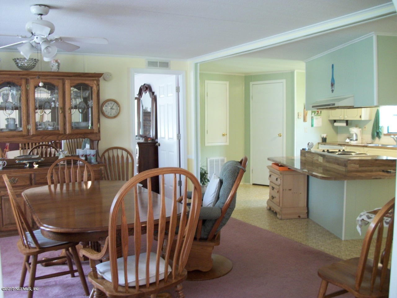 2855 Parrish Cemetery Road Jacksonville, FL 32221 - Photo 8 of 16 a dining room with furniture a livingroom view and windows