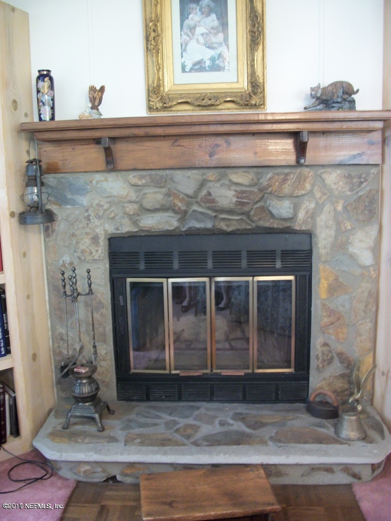 2855 Parrish Cemetery Road Jacksonville, FL 32221 - Photo 9 of 16 a living room with a fireplace