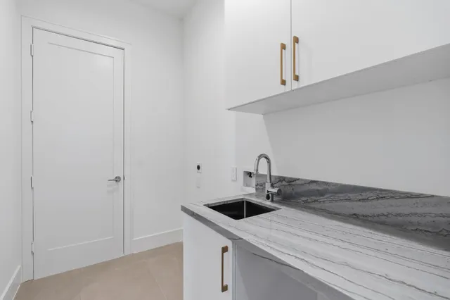 a kitchen with a sink and cabinets