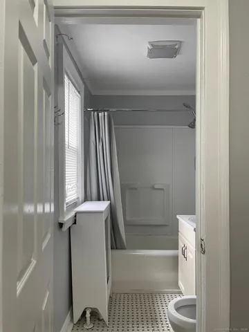 a bathroom with a tub and toilet