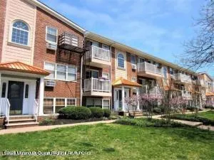 a front view of a building with a yard